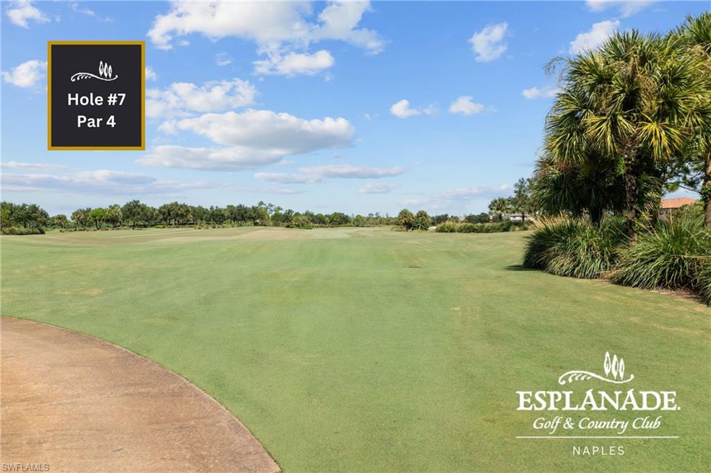 Expansive golf course fairway with manicured turf, bordered by mature palm trees and lush landscaping