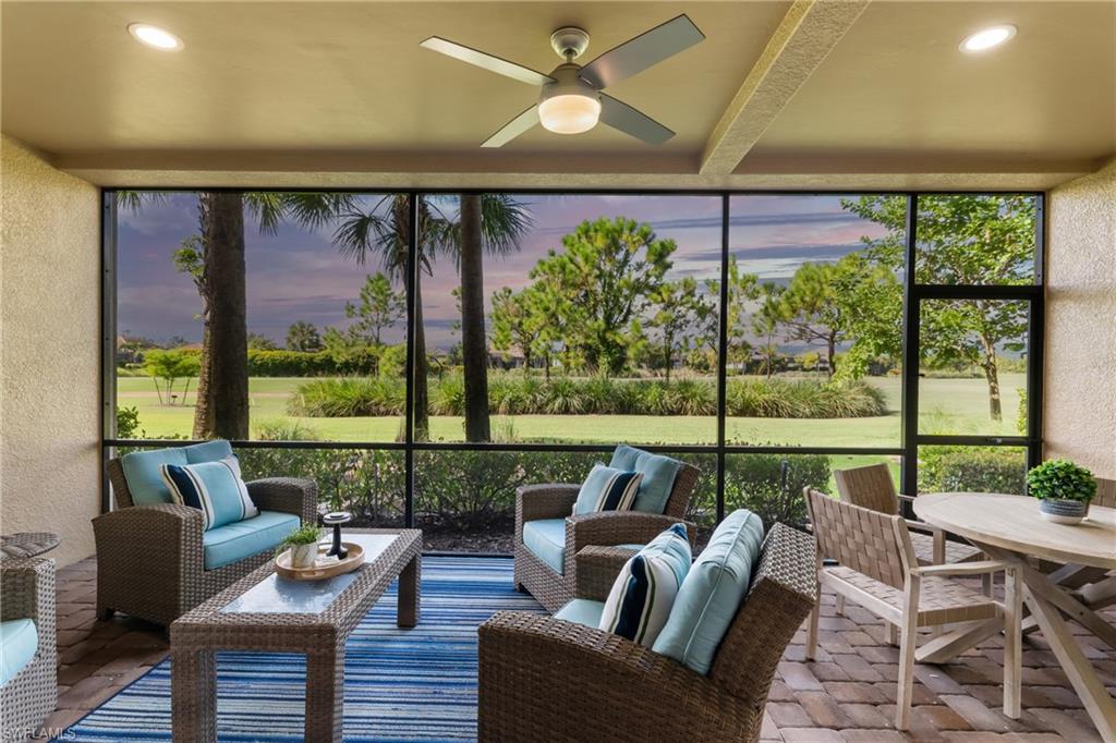 Screened lanai featuring paver flooring, recessed lighting, and an overhead ceiling fan