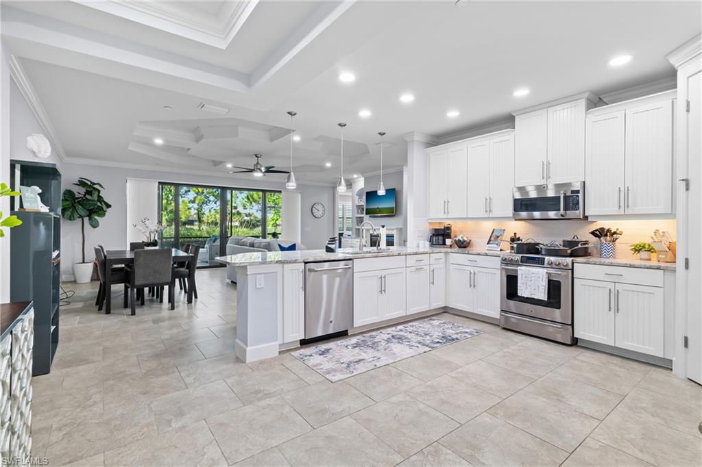Kitchen featuring white cabinetry, stainless steel appliances, and light-toned countertops