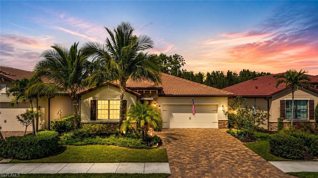 Rich wood-finish cabinetry, stainless steel appliances, light-toned tile flooring, and granite countertops