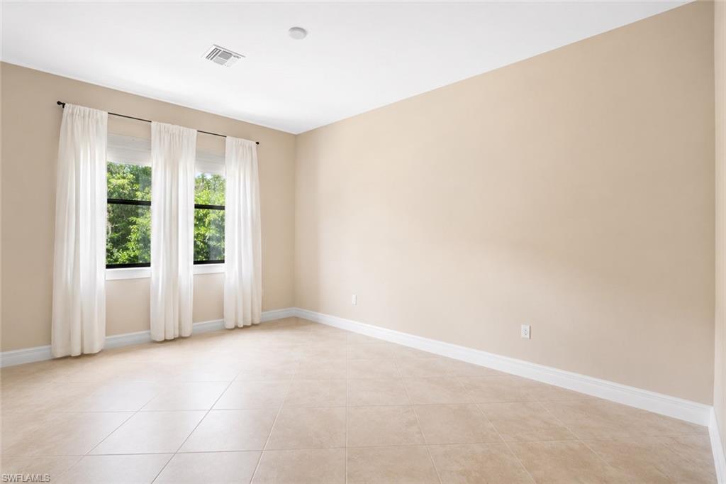 Neutral-toned walls complement the tile flooring
