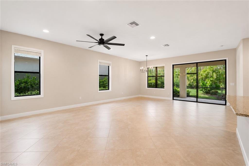 Spacious room with large format tile flooring, recessed lighting, and a contemporary ceiling fan