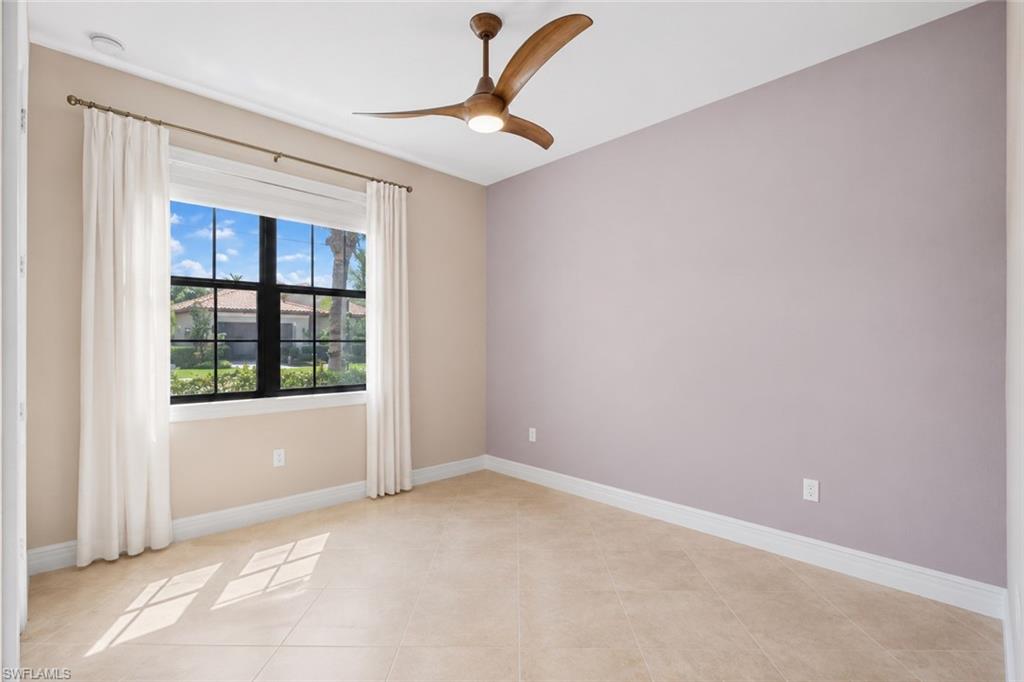 Recessed lighting, ceiling fan with wood-finish blades, tile flooring, and a window with black muntins