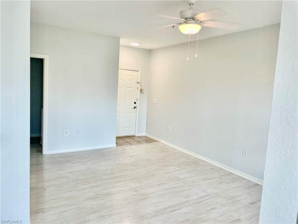 Unfurnished room with light hardwood / wood-style flooring and ceiling fan