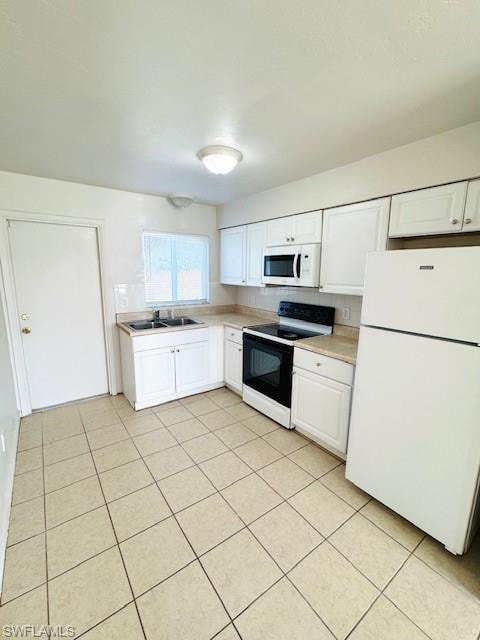 Kitchen featuring white cabinetry, tile flooring, a window, and a complete suite of appliances