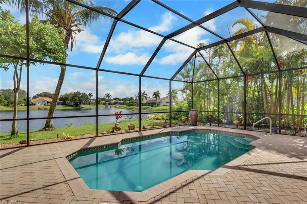 Screened pool enclosure with a geometric pool, integrated steps, and a handrail