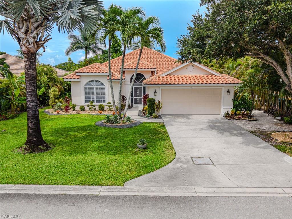Mediterranean-style architecture with an arched entry and a terracotta tile roof