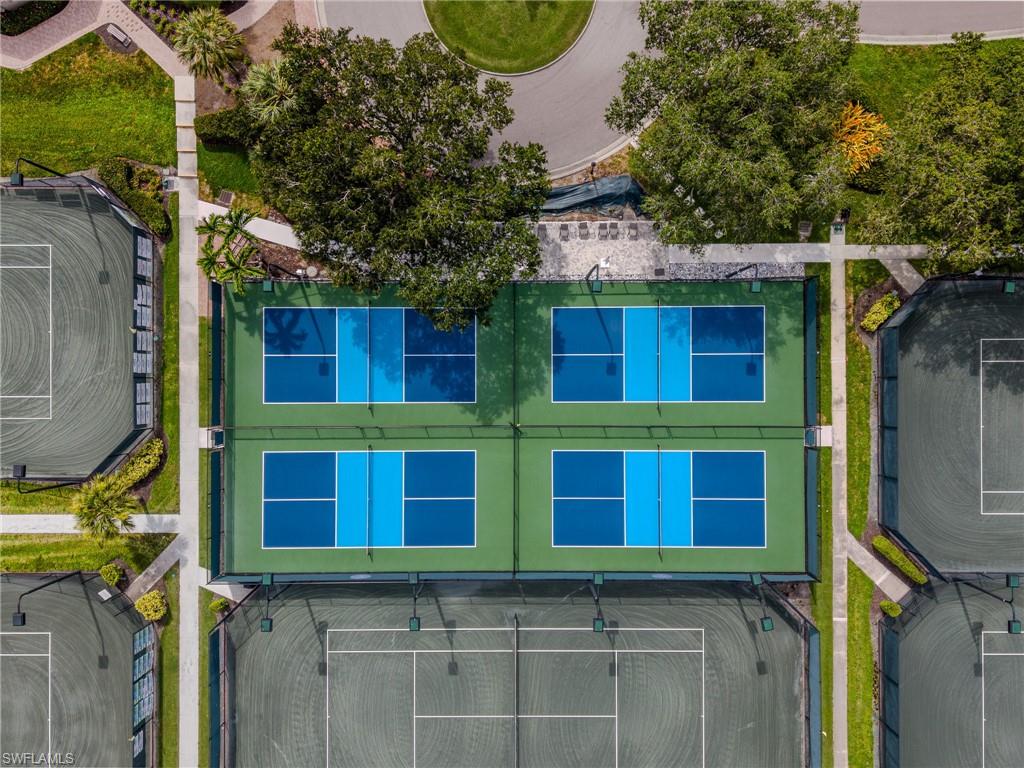 Multiple tennis courts and pickleball courts with defined playing areas
