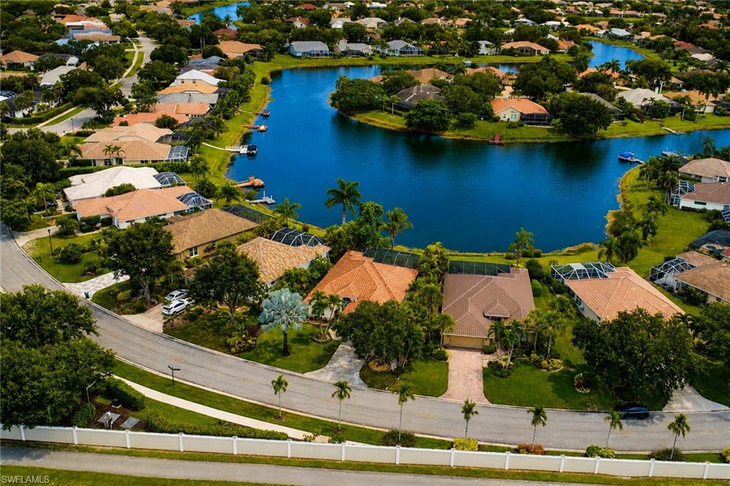 Waterfront residential community featuring a meandering waterway, mature trees, and landscaped properties