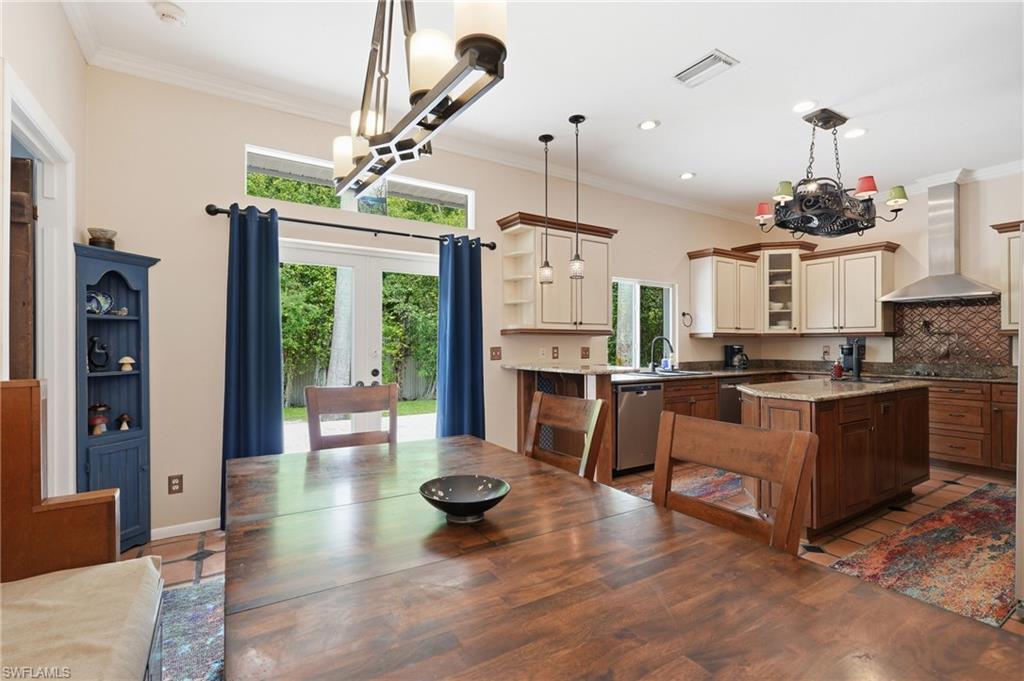 OPEN CONCEPT DINING AREA WITH FRENCH DOORS LEADING OUT TO EXPANSIVE PATIO DECK FOR OUTDOOR LIVING, ENTERTAINING, AND DINING...