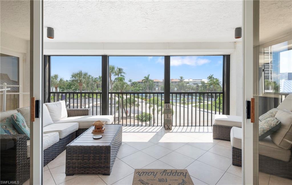 Sunroom featuring a textured ceiling and tile patterned floors