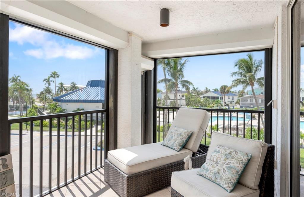 Balcony featuring a sunroom and view of pool