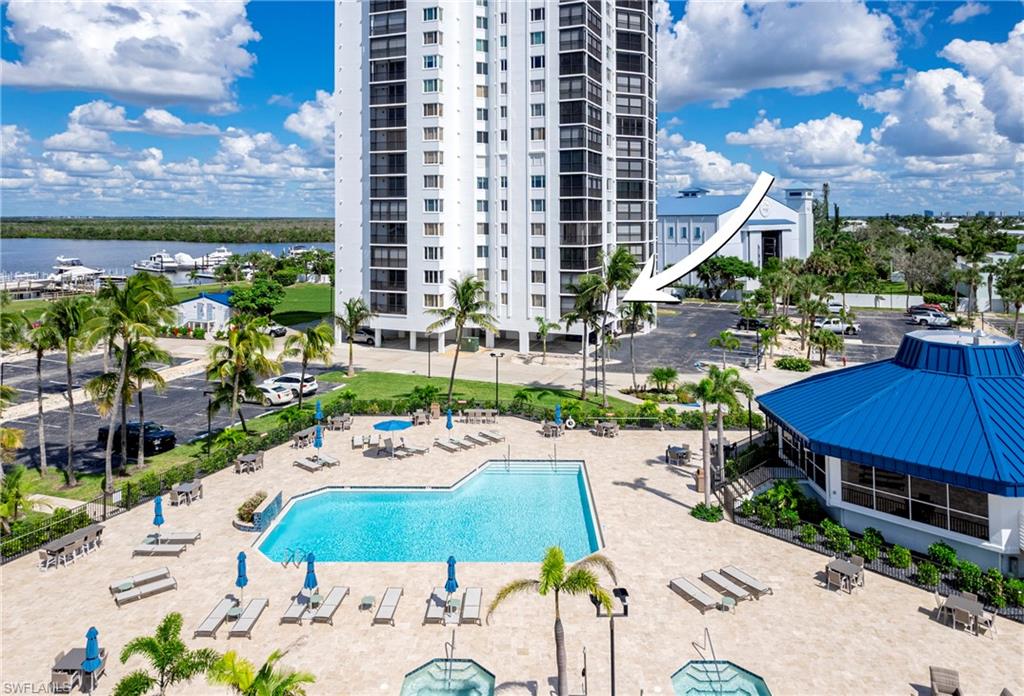 Community pool with a water view and a patio
