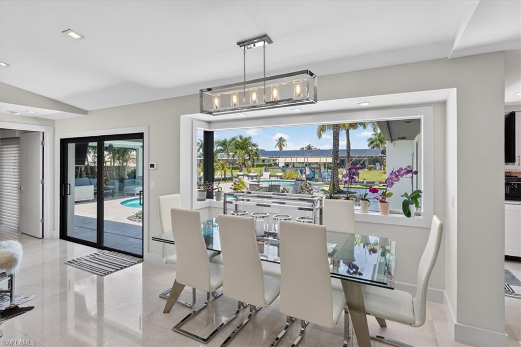 Dining area with large impact window to back yard oasis