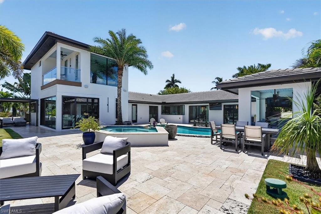 Huge travertine pool deck with plenty of seating for all