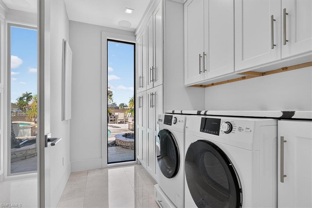 Full Laundry room with storage inside the home