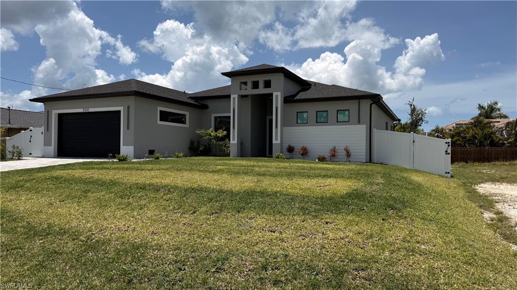 Contemporary single-story residence with a dark shingle roof and light gray stucco exterior