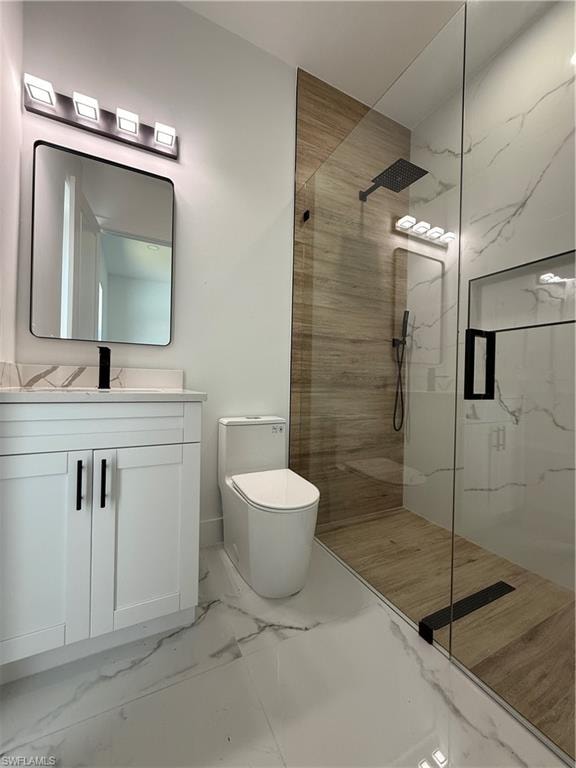 Modern bathroom featuring a glass-enclosed shower, wood-finish wall and floor tiling, and a white vanity with a rectangular sink