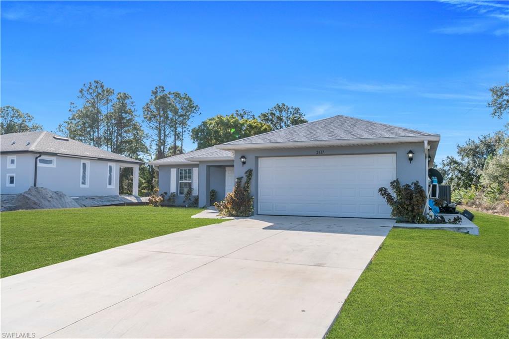 Concrete driveway leading to a two-car garage