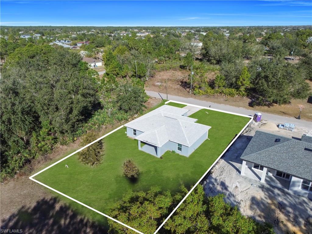 Single-story residence featuring a light gray exterior and a shingled roof