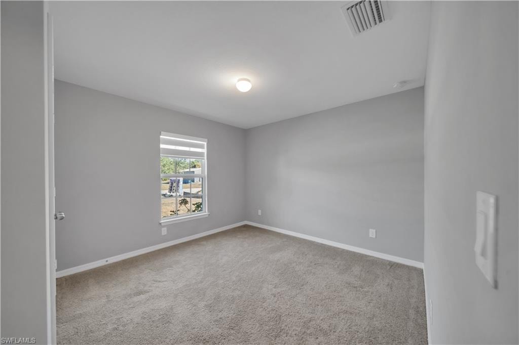 Carpeted room with a single window, white window blinds, and light-colored walls