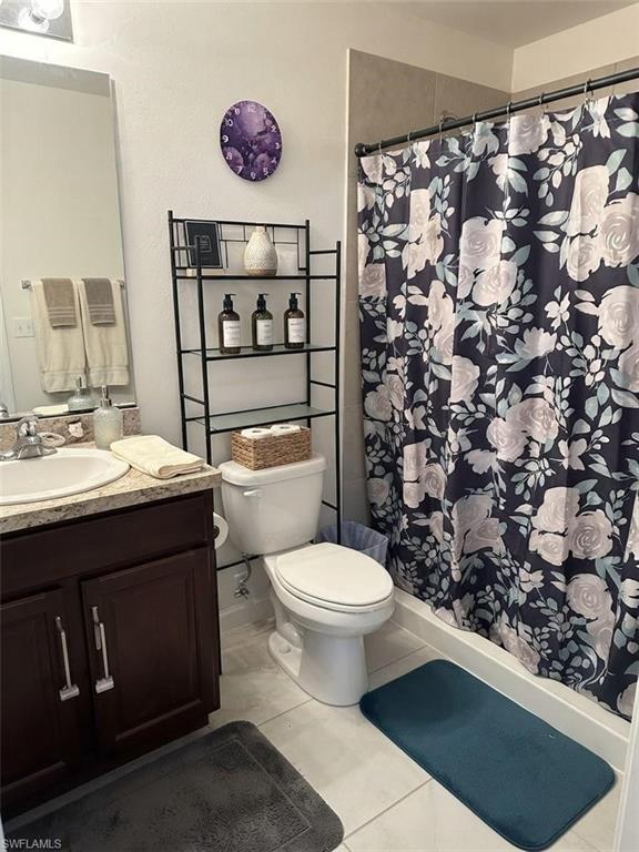Vanity with a single sink, dark wood-finish cabinetry, and a light-toned countertop