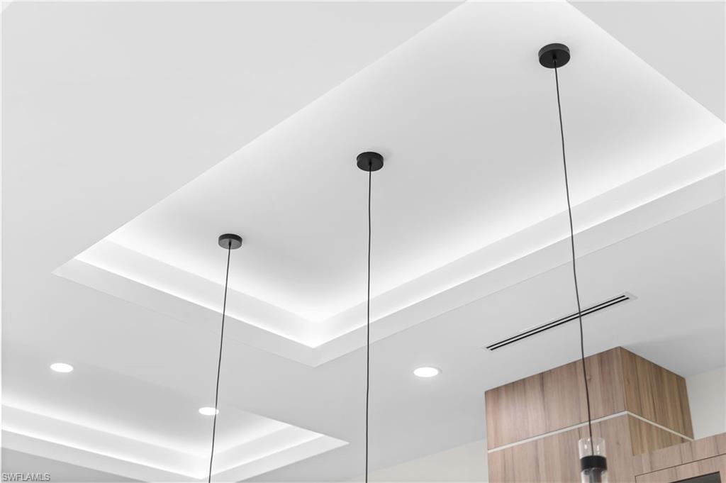 Tray ceiling with integrated lighting, recessed lighting, and suspended pendant lights