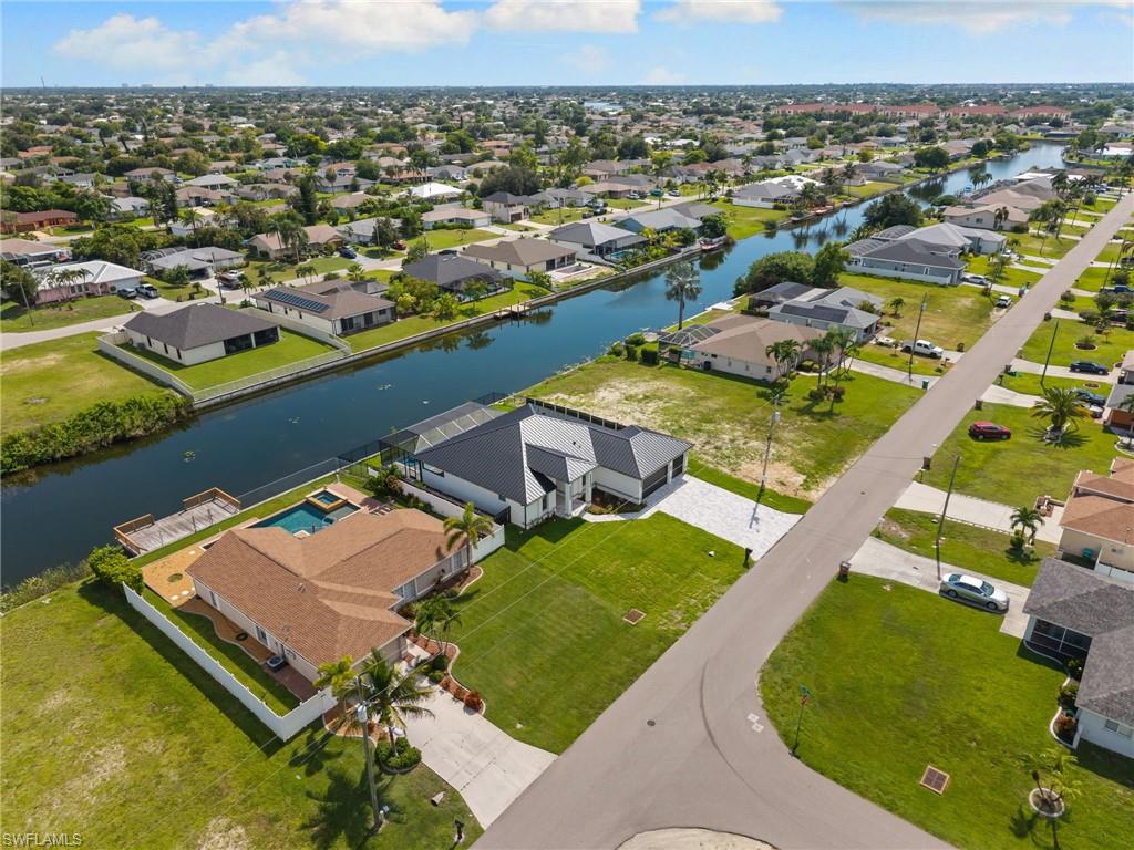 Property featuring a canal-front location, private dock, screened lanai, and swimming pool
