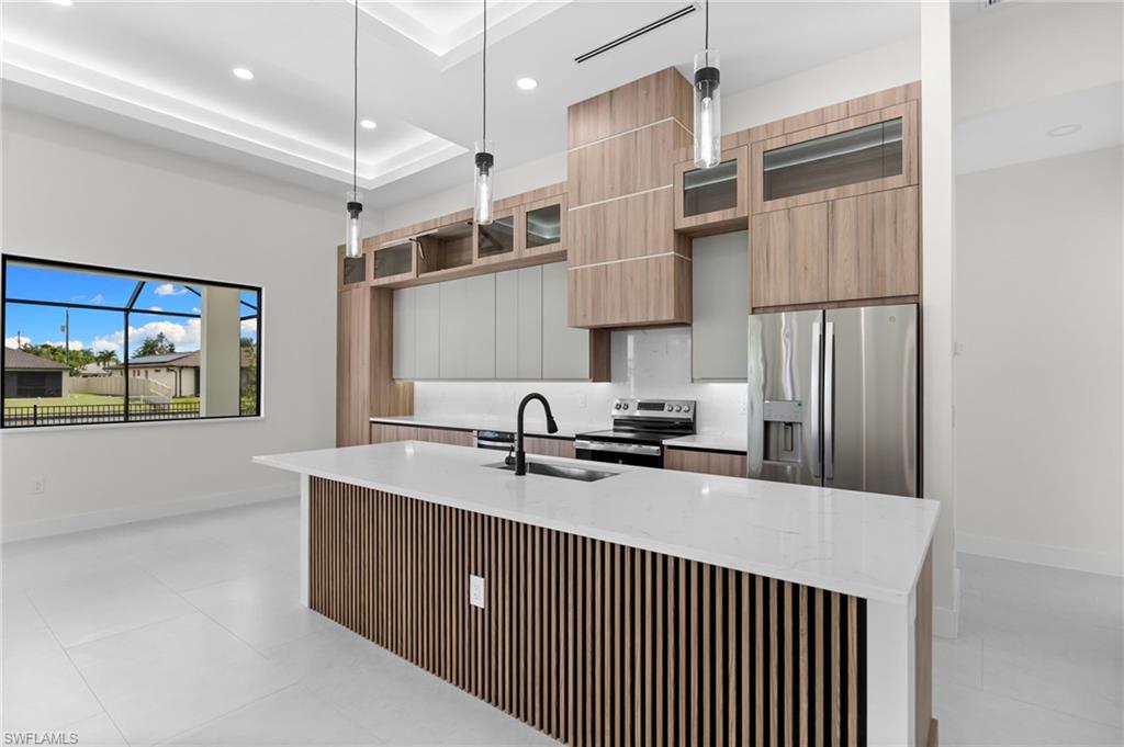Kitchen featuring an island with wood-finish slat paneling, a white countertop, and a black gooseneck faucet