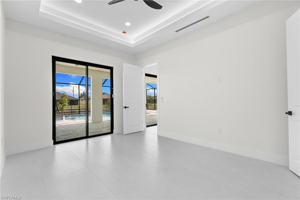Sliding glass doors opening to a screened patio and swimming pool