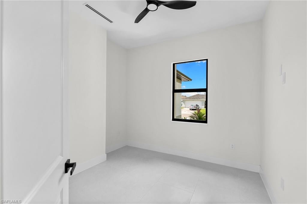 White walls, light-toned flooring, and a ceiling fan