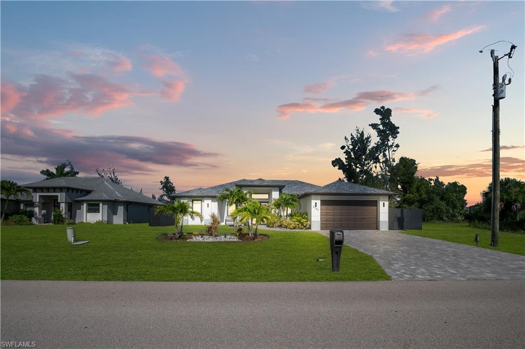 Paved driveway leading to a two-car garage with a wood-look door