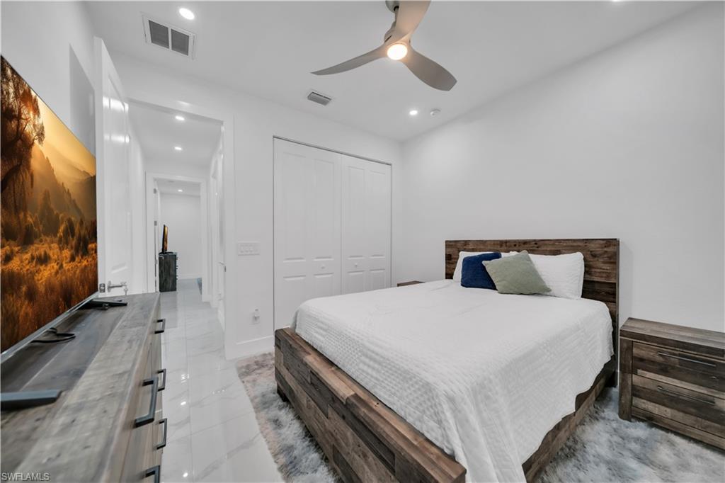Recessed lighting, wood-finish flooring, ceiling fan, and white painted walls