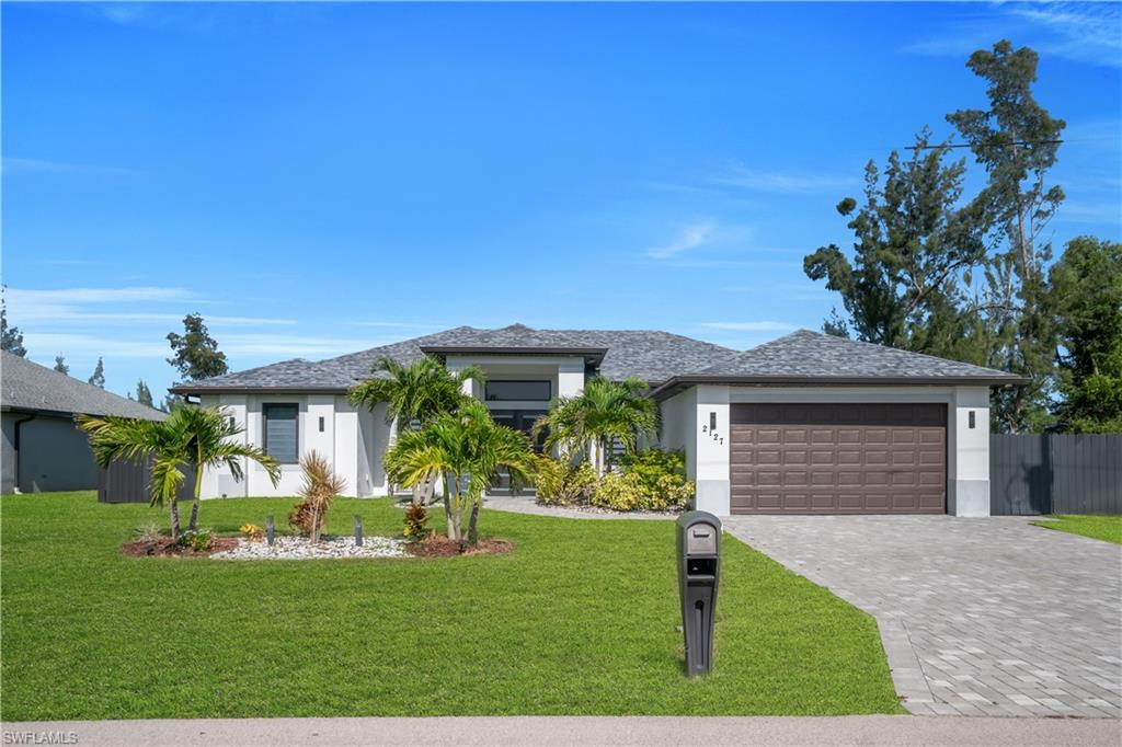 Modern exterior with stucco finish and a shingle roof