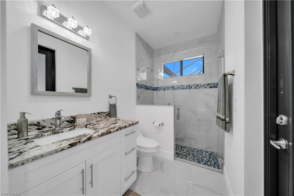 White vanity with an integrated sink and stone countertop