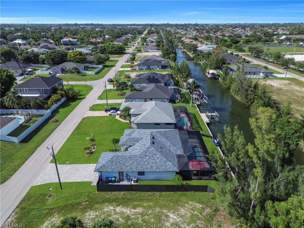 Property featuring a screened-in pool enclosure, private boat dock, and canal frontage