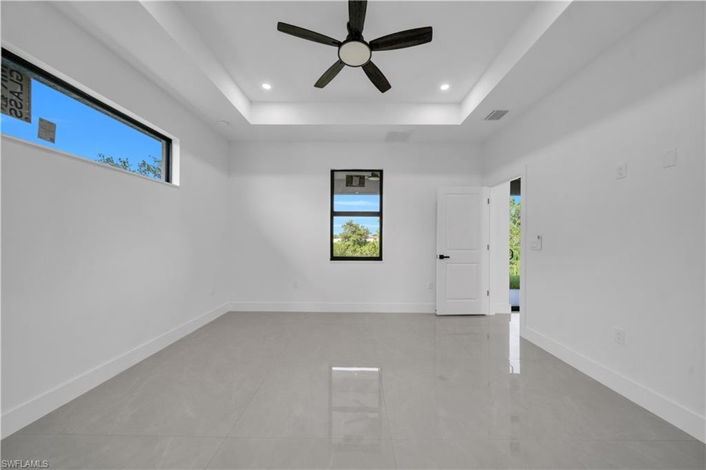 Recessed lighting, tile flooring, and white bi-fold closet doors