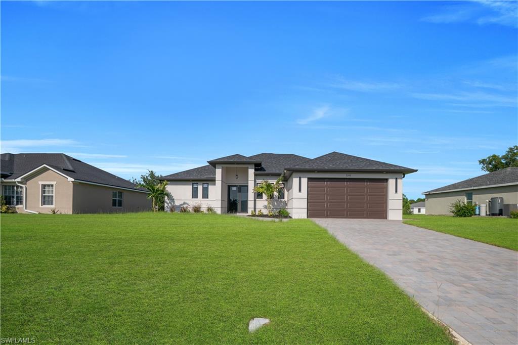 Contemporary stucco exterior with dark shingle roof and a spacious two-car garage