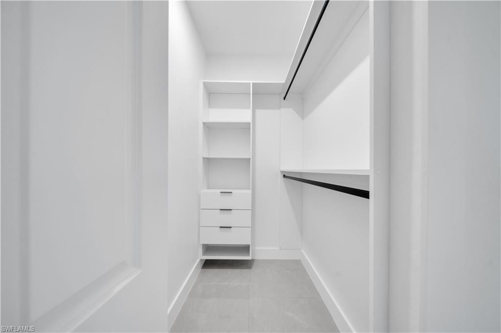 Built-in closet system with shelving, drawers, and hanging rods