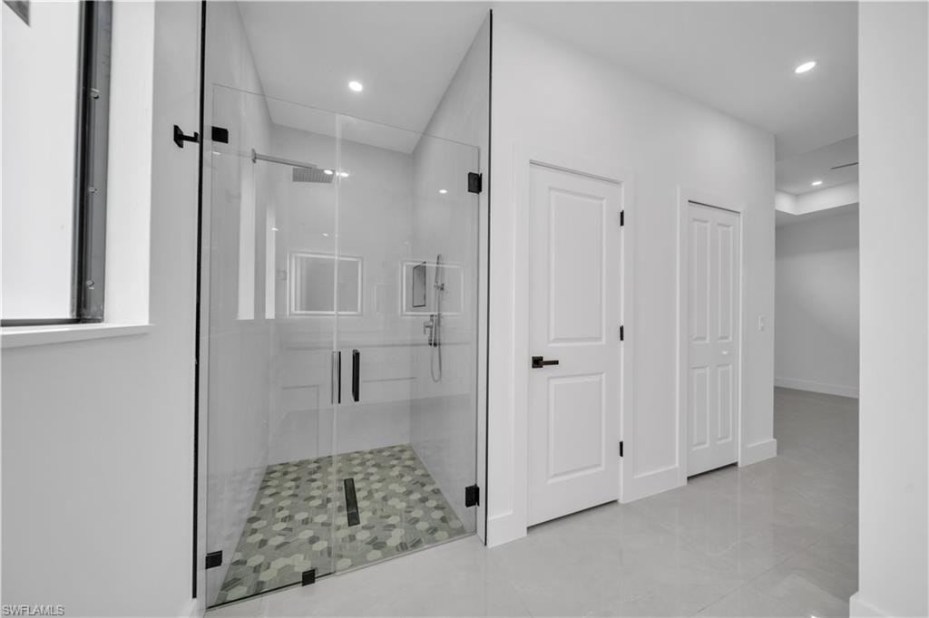 Dual vessel sinks with modern chrome faucets, complemented by two illuminated square mirrors