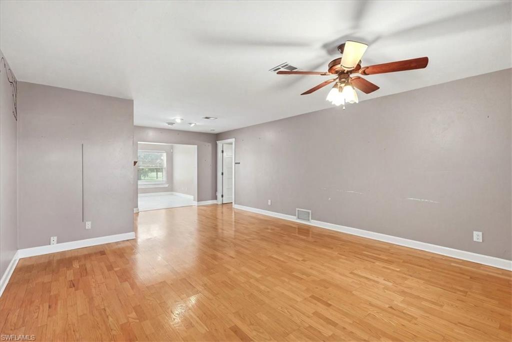 Wood-finish flooring throughout, ceiling fan with integrated lighting, and recessed ceiling lights