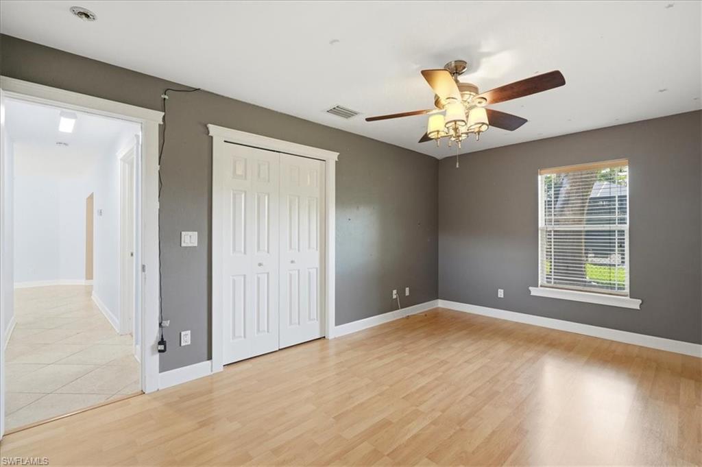 Wood-finish flooring with a ceiling fan light fixture