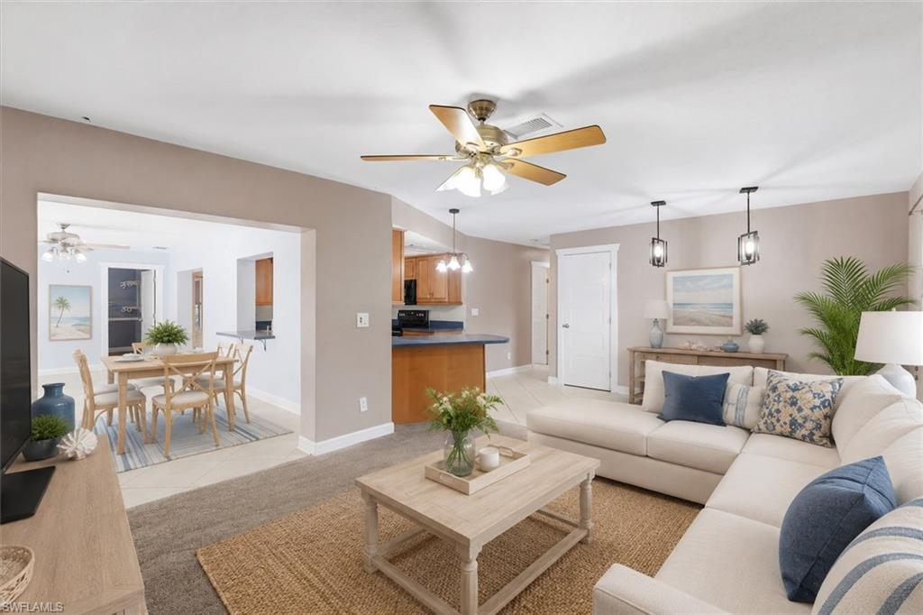 Open concept living area featuring a ceiling fan, recessed lighting, and pendant lighting