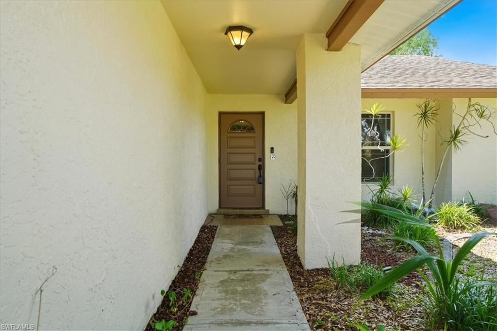 Covered entry with stucco exterior