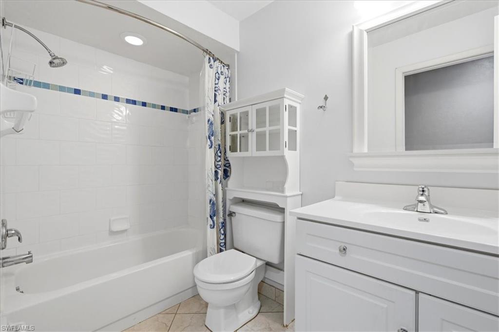 White vanity with integrated sink and chrome faucet