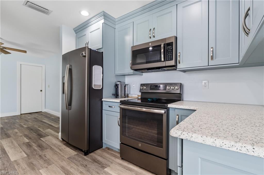 Kitchen with ceiling fan, recessed lighting, visible vents, light wood-style floors, and appliances with stainless steel finishes
