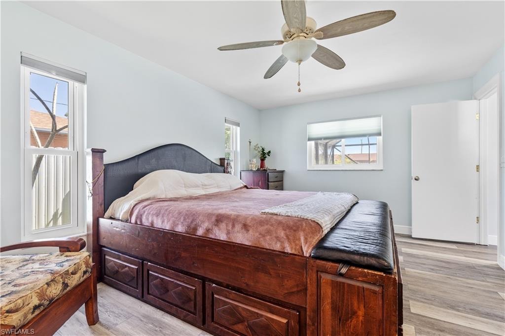 Bedroom with ceiling fan and light wood finished floors