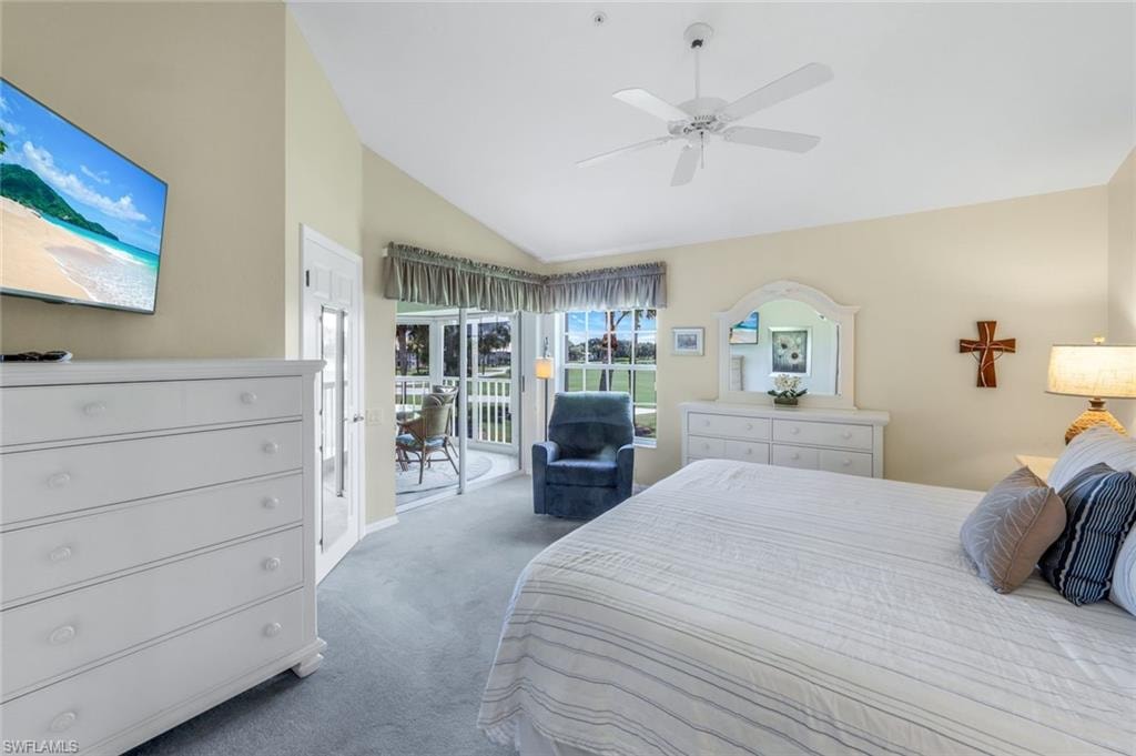 Carpeted bedroom with access to exterior, high vaulted ceiling, and ceiling fan