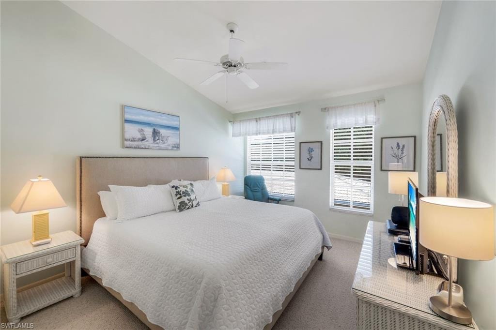 Bedroom with TV carpet floors, lofted ceiling, and a ceiling fan