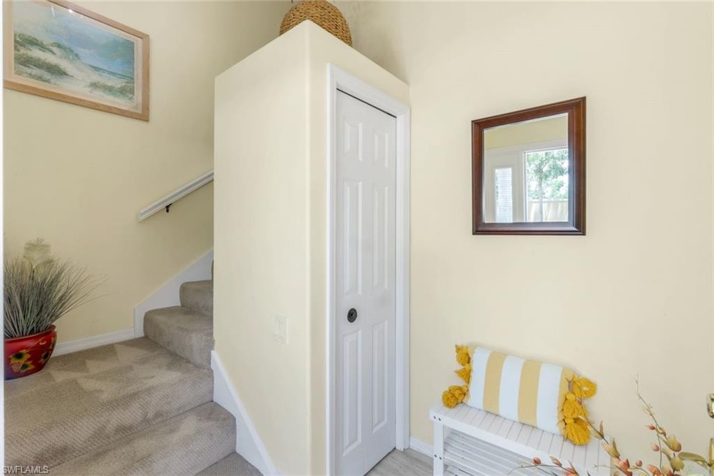 Stairway featuring baseboards and carpet floors